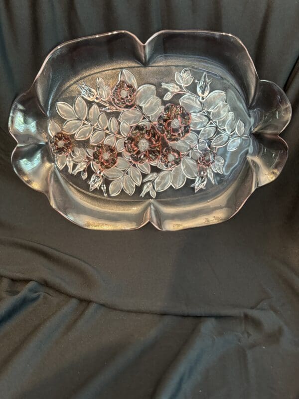 A silver tray with flowers on it