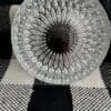 A glass bowl sitting on top of a checkered rug.