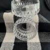 A close up of two glass bowls on top of a table