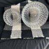 A black and white checkered mat with two plates on it.