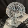 A close up of a glass plate on top of a black and white cloth.
