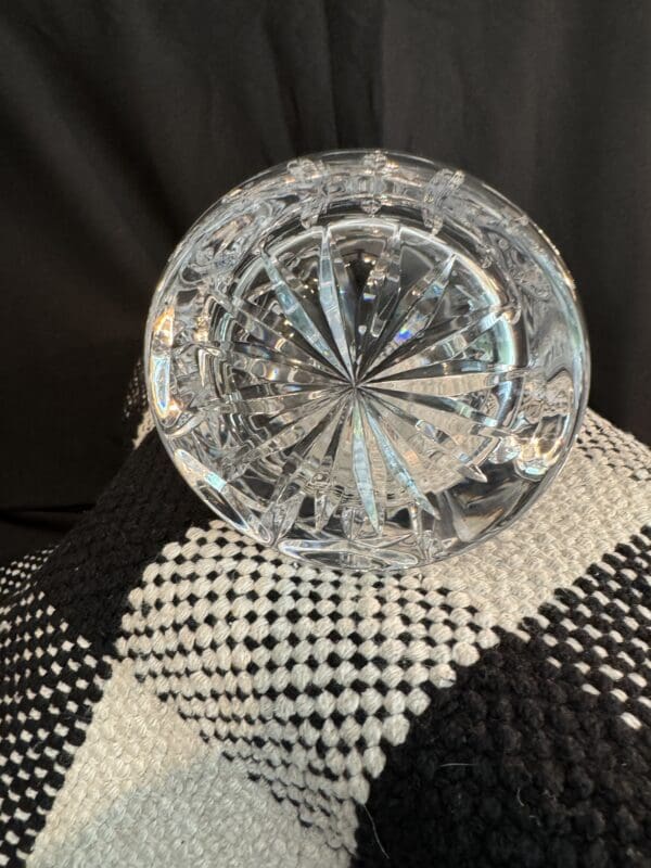 A close up of a glass plate on top of a black and white cloth.