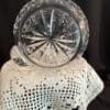 A glass bowl sitting on top of a crocheted doily.