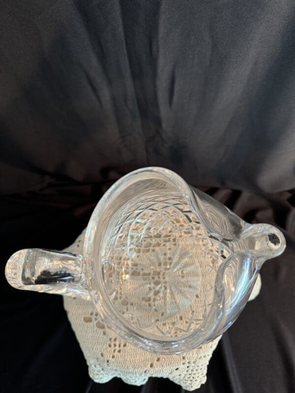 A silver pot sitting on top of a table.