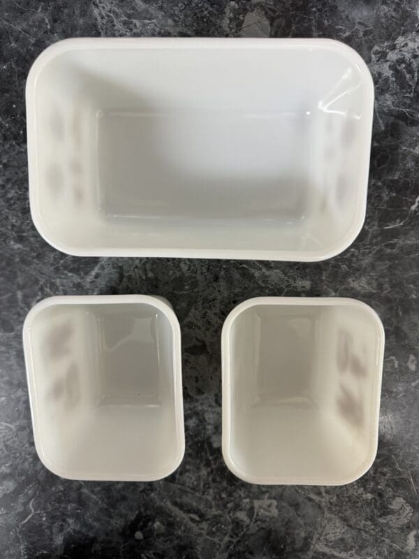 A white container with two smaller ones and one larger one.