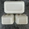 Three white cubes are sitting on a table.