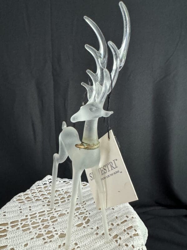 A white deer statue sitting on top of a table.