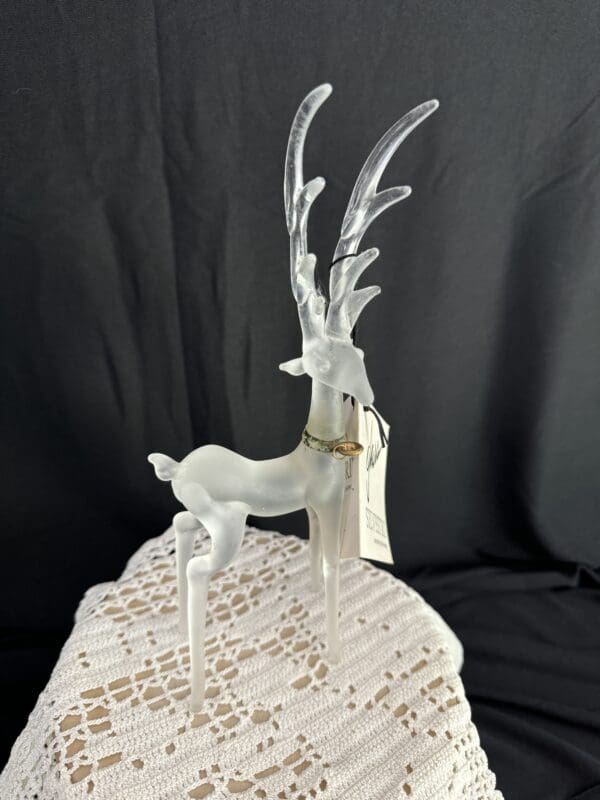 A white deer with long horns on top of a table.