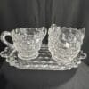 A glass tray with two cups on it