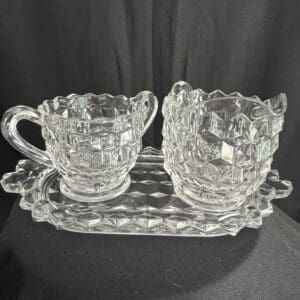 A glass tray with two cups on it