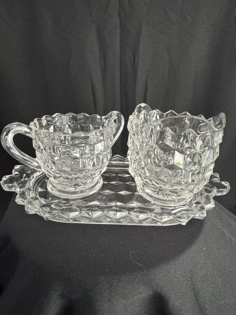 A glass tray with two cups on it