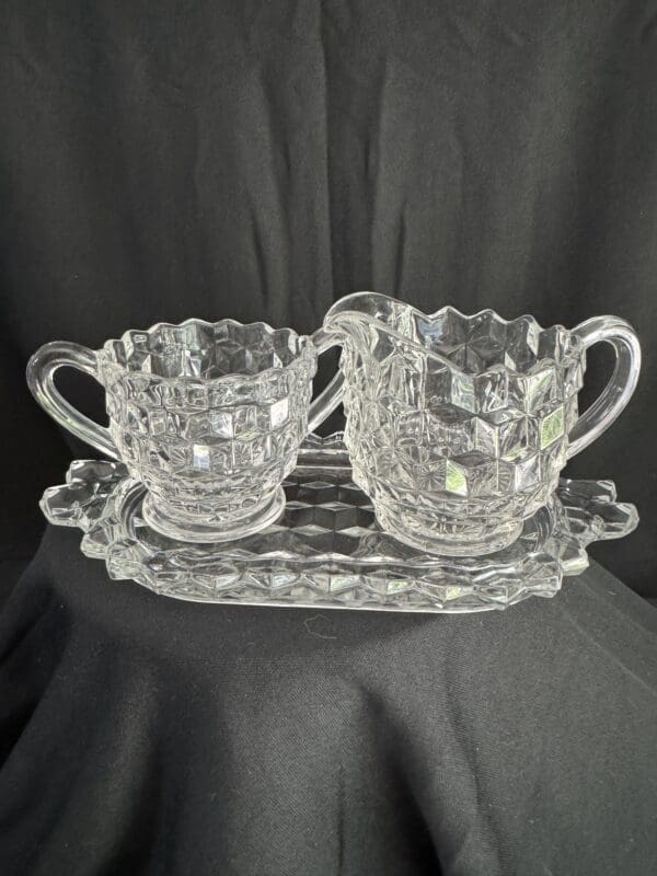 A glass tray with two cups on it