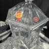 A clear glass container with a lid on top of a table.
