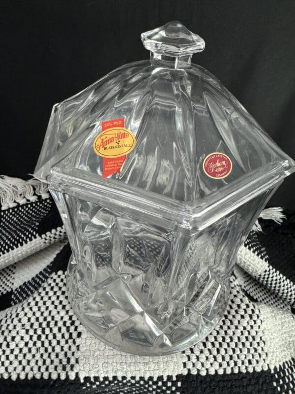 A clear glass container with a lid on top of a table.