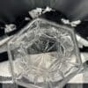 A glass candle holder sitting on top of a table.