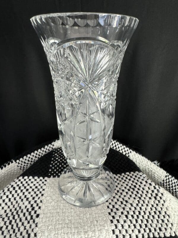 A clear glass vase sitting on top of a table.