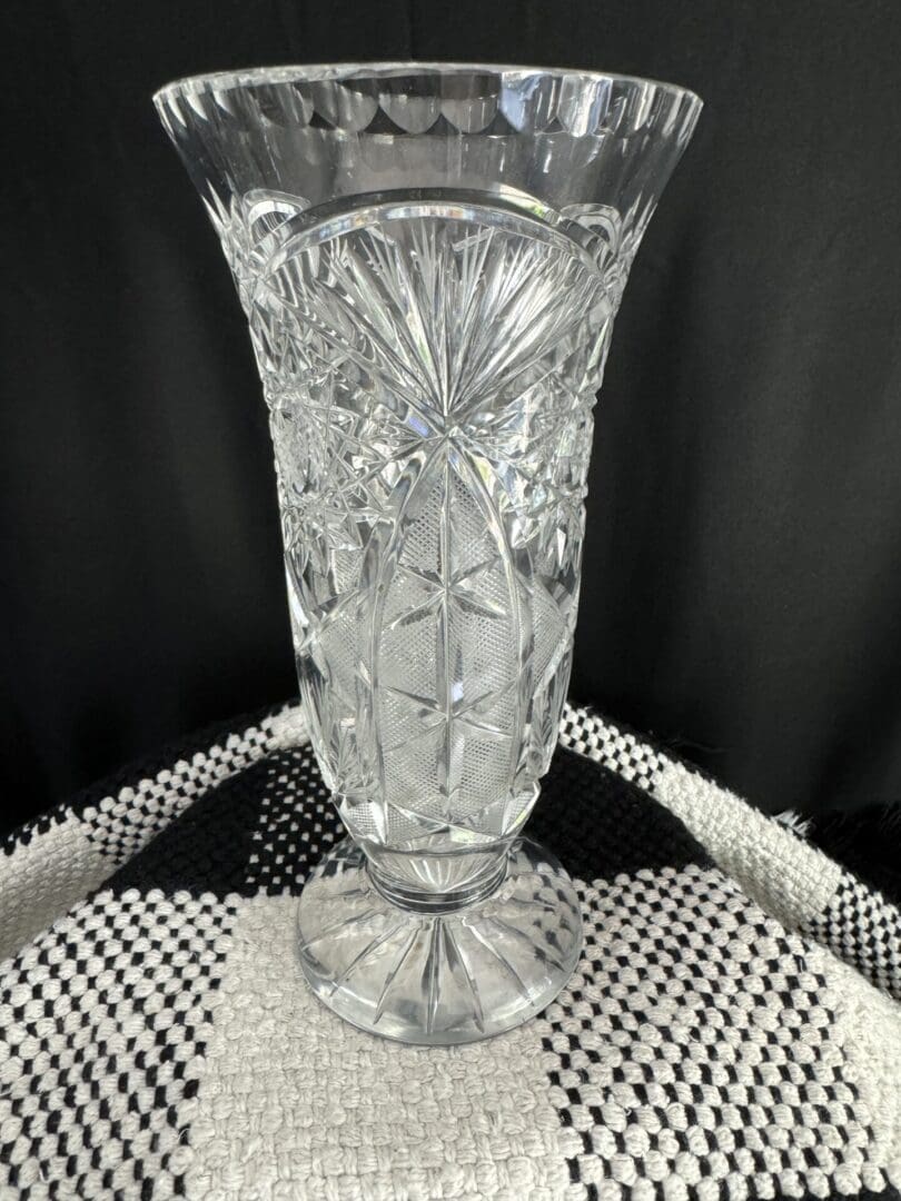 A clear glass vase sitting on top of a table.