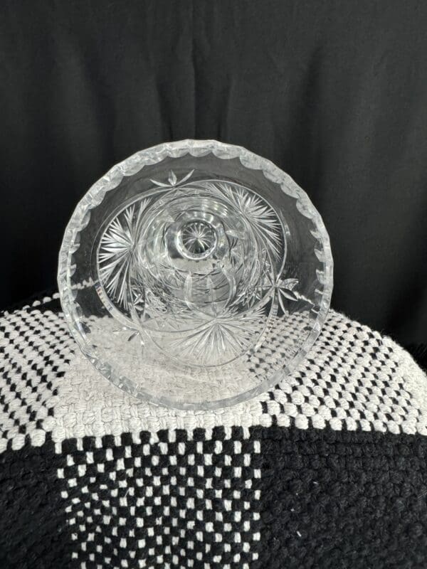 A glass plate and bowl on top of a black table.