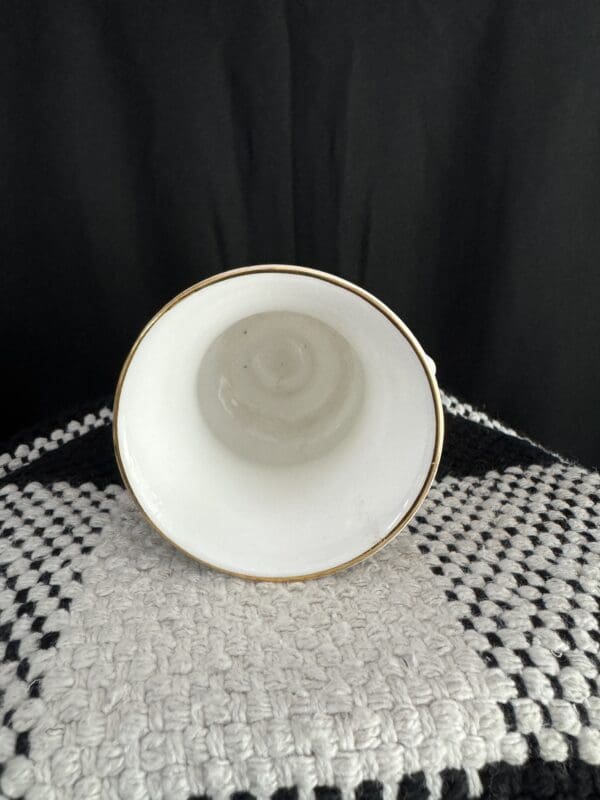 A white bowl sitting on top of a table.