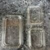Three plastic containers sitting on a table.