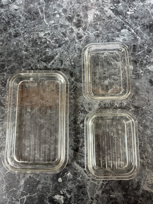 Three plastic containers sitting on a table.