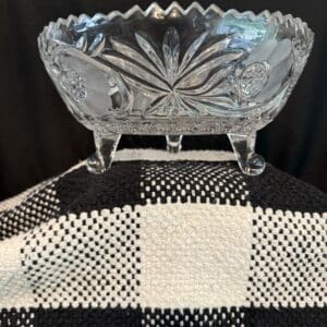 Crystal bowl on a checkered fabric surface.