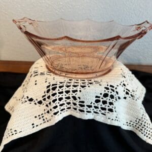 Glass bowl on a lace tablecloth.