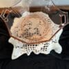 Glass bowl on a decorative lace doily.