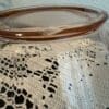 Clear glass container on lace tablecloth.