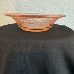 Pink glass dish on black tablecloth.